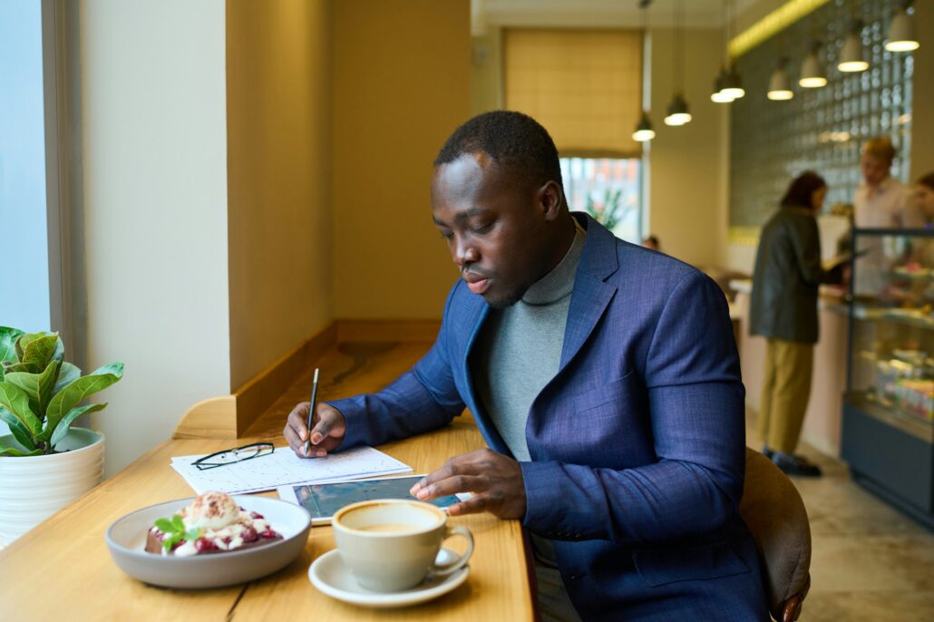 Businessman working on tablet pc at cafe