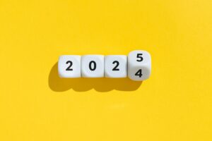 New year from 2024 to 2025 concept. Text on cube blocks isolated on yellow background